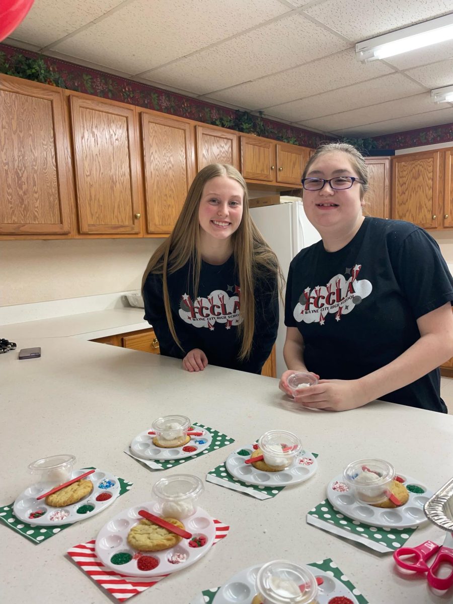 Emma Griswold and Jaycee Youngblood prepare for the cookie decorating event with FCCLA.